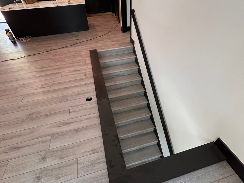 Luxury vinyl plank flooring installed on a staircase and landing in Grand Rapids, Michigan