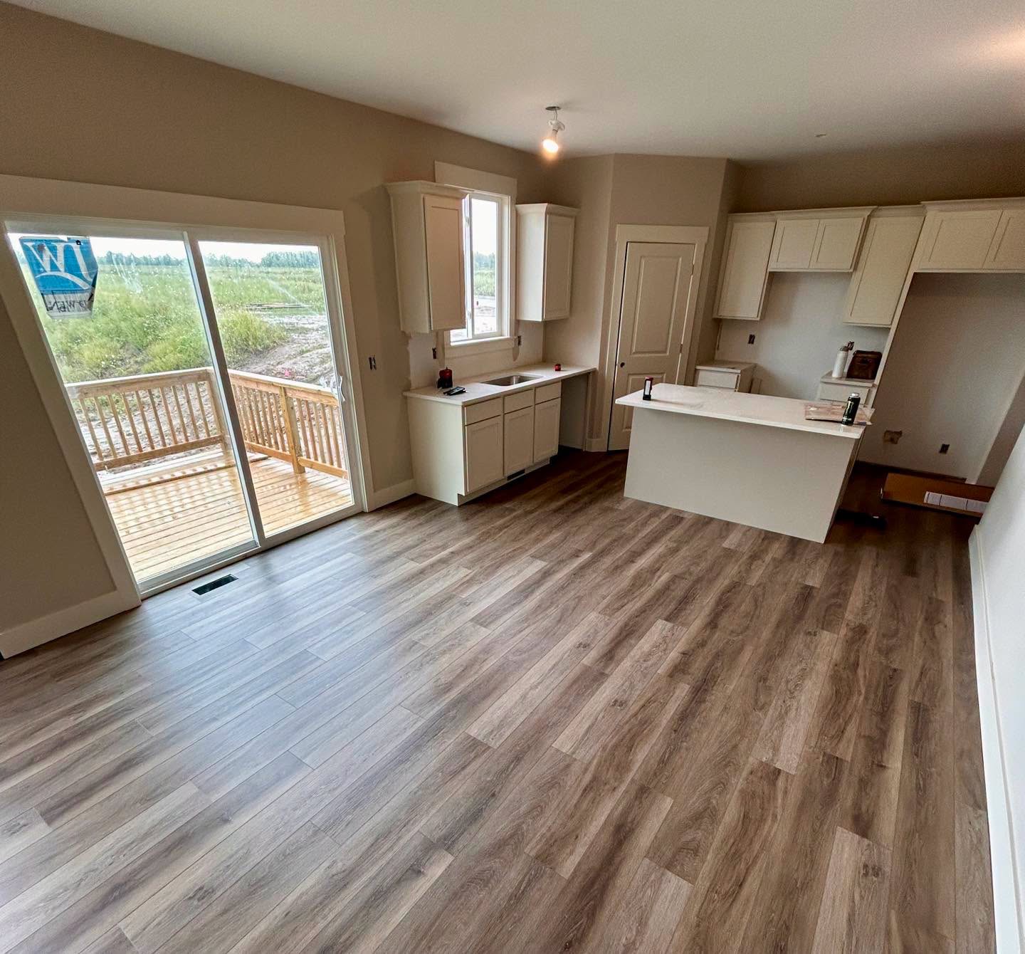 Wood-look plank flooring installed around a white kitchen island.
